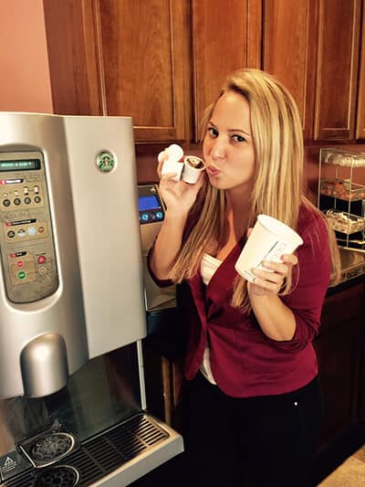 Malley holding k cups in front of the coffee maker