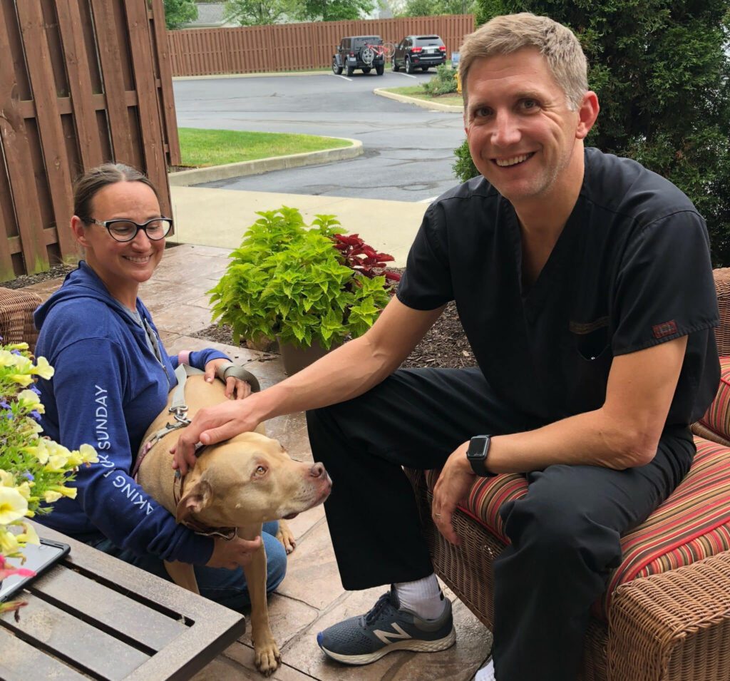 Dr. Wiley visiting with a therapy dog at ClearChoice
