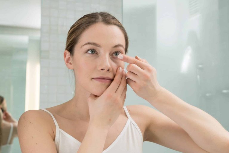 Woman putting in Contact Lenses