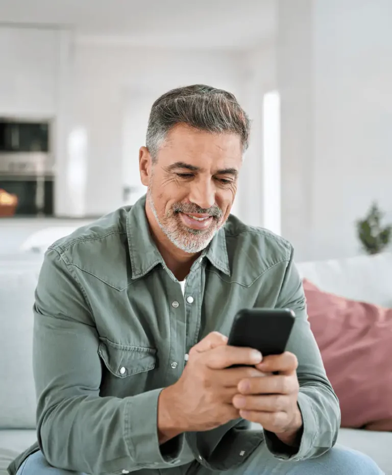 Man reading his smartphone without glasses