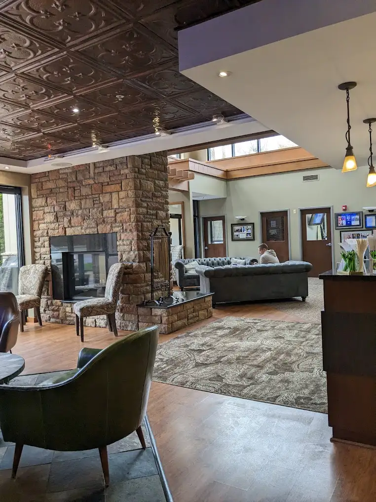 Waiting area with a stone fireplace at Clear Choice Vision Correction
