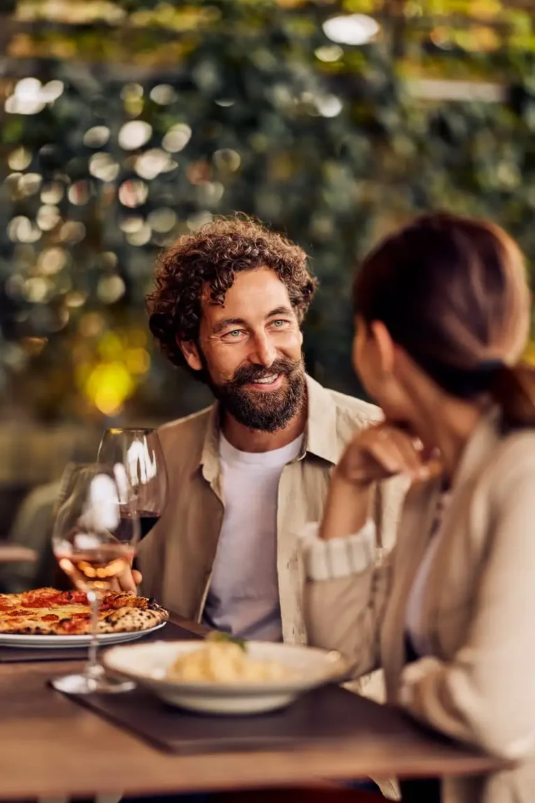 Man enjoying dinner and conversation without glasses